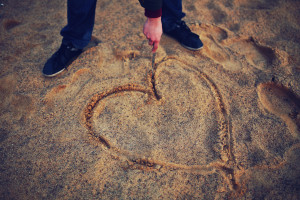 person drawing heart in sand | 50 Romance Plot Ideas and Romance Writing Prompts #5000 writing prompts free ebook #5000 writing prompts pdf #cute romance plot ideas #plot ideas romance #romance plot generator #romance plot ideas #romance writing prompts #unique love story ideas #dark romance plot ideas