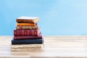 STEAL THIS PLOT: 50 Good Story Plot Ideas from Victorian and Regency Novels | a stack of old books with leather bindings