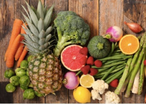 Image of many fruits and vegetables: pineapple, grapefruit, broccoli, carrots, and more.