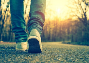 image of someone's feet walking down the road