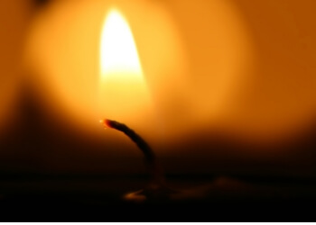 Close-up of a candle flame in the darkness.