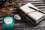 Notebook, heather flowers, candles