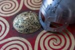 Viking helmet and Norse metalwork on cloth with Viking symbols