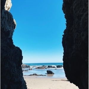 a view of the sky and ocean between two cliffs at Leo Carillo Beach