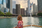 Bryn Donovan on a boat on the Chicago river with skyscrapers in the background