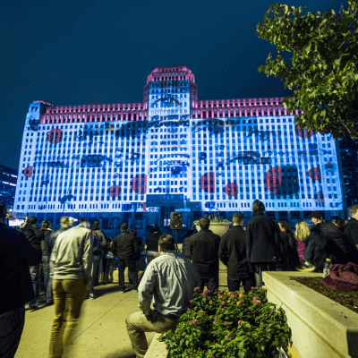 people watching a video installation on Chicago's Merchandise Mart building