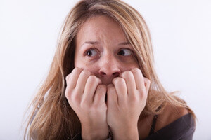 woman covering her mouth in fear