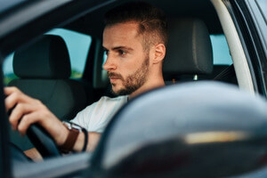 man driving car