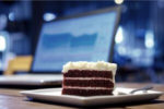 slice of cake and laptop computer