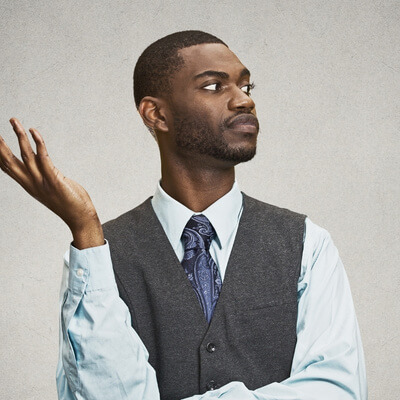 black man with annoyed expression, staring, one hand held up in disbelief