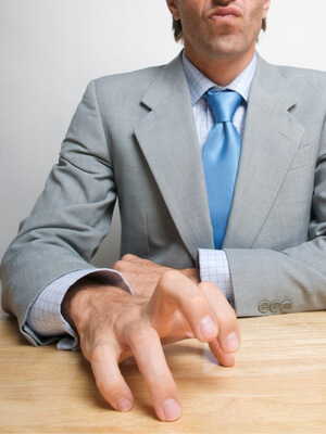 tapping fingers on desk - annoyed body language