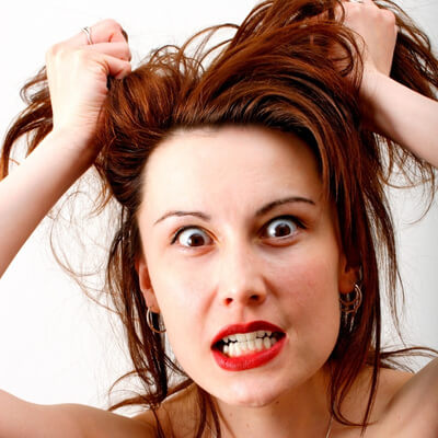 white woman with angry expression grabbing hair