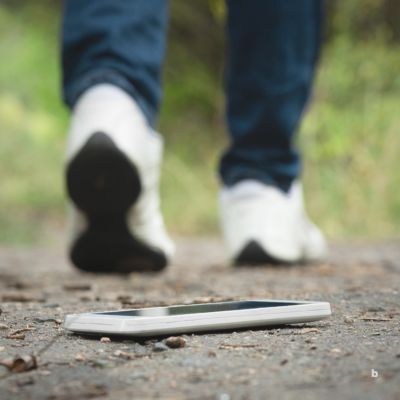 phone on ground, person walking away to quit doomscrolling