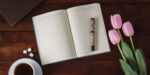 tulips, open journal, coffee, representing may writing prompts