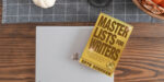 the book Master Lists for Writers by Bryn Donovan, on a laptop on a table
