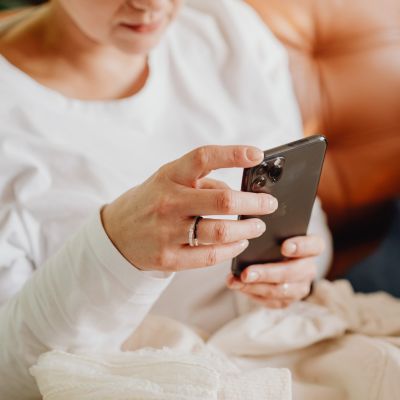 close up of hands, woman looking at phone