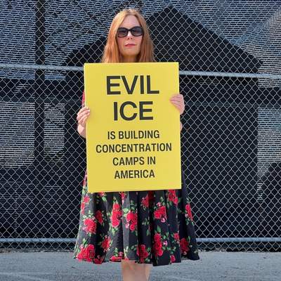 me at Broadview ICE detention center in Illinois, holding up sign that says Evil ICE is building concentration camps in America