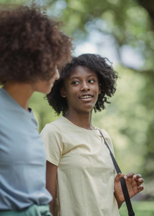 two women walking outdoors and talking - writing dialogue