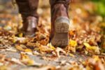 close up of boots crunching on fall leaves on road, for Descriptive Words about Autumn