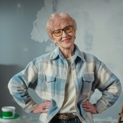 older woman taking a break from painting a room - writing about old people